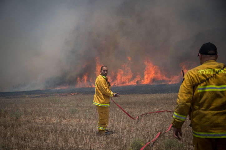 Israeli firefighters extinguish a fire