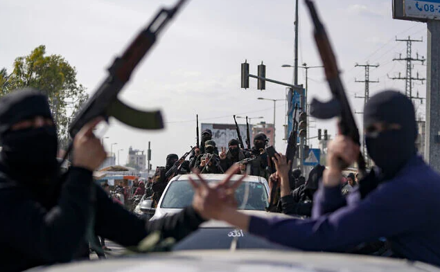 Members of the al-Qassam Brigades, the armed wing of Hamas, take part in a parade as they celebrate