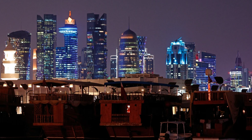 Illuminated skyscrapers are pictured along the Corniche promenade in Doha, June 29, 2026. Photo by Karim Jaafar/AFP via Getty Images.