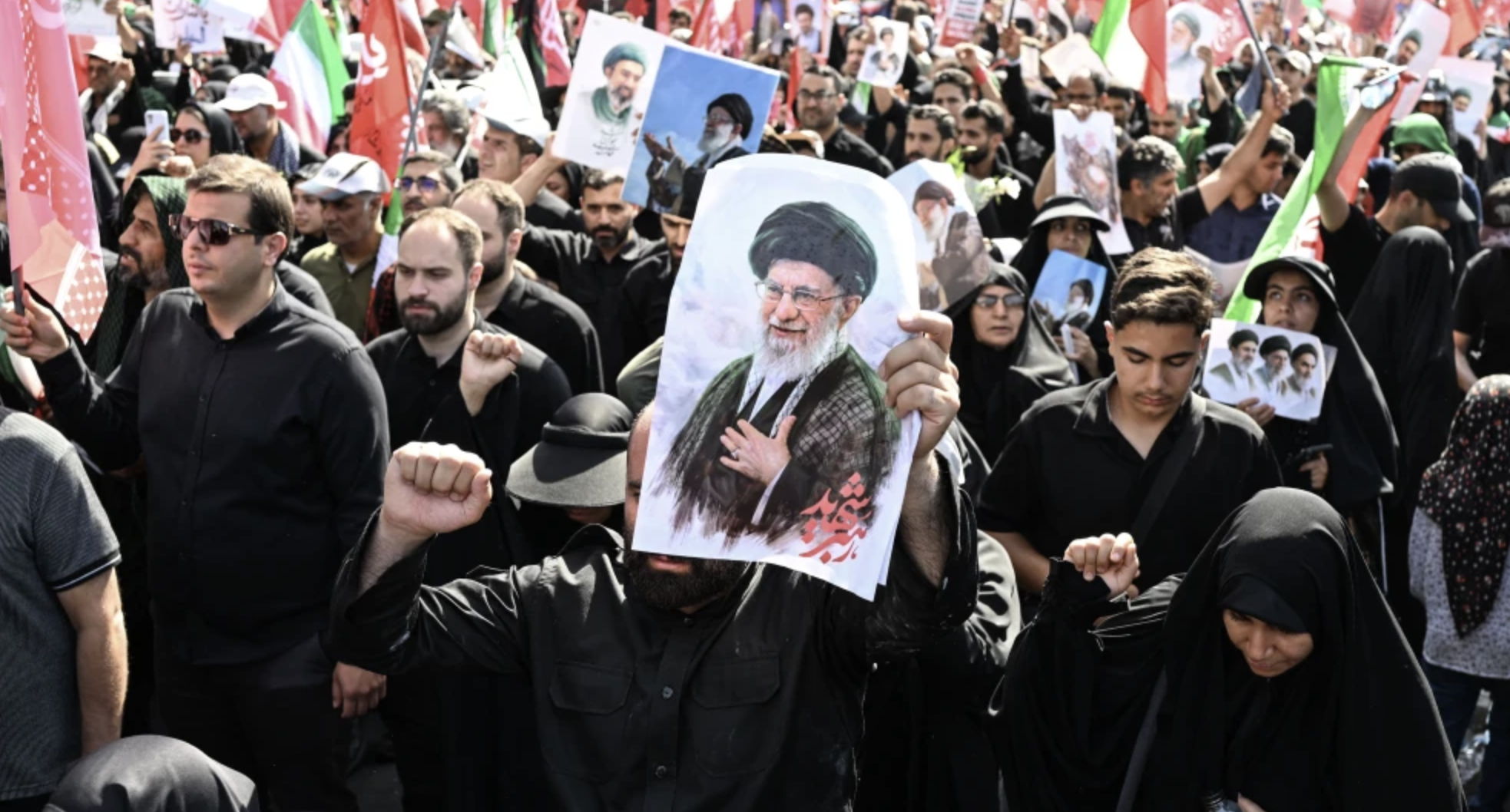 An Iranian regime security officer stands guard as people gather at Tehran’s Ferdowsi Square for the funeral procession of slain Supreme Leader Ali Khamenei, July 6, 2026. Photo by Wakil Kohsar/AFP via Getty Images.