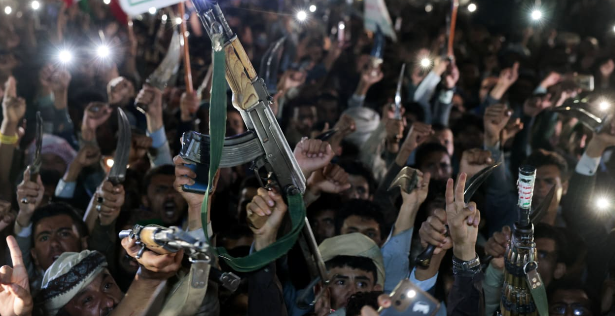 Houthi supporters hold up weapons as they demonstrate against airstrikes on Sanaa International Airport, in Sanaa, Yemen July 13, 2026. (photo credit: KHALED ABDULLAH/REUTERS)