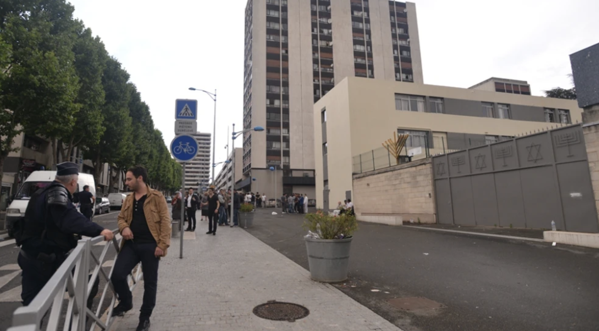 A member of the Jewish community of Sarcelles speaks with a police officer protecting the building from anti-Israel rioters on July 20, 2014. Photo by Canaan Lidor.