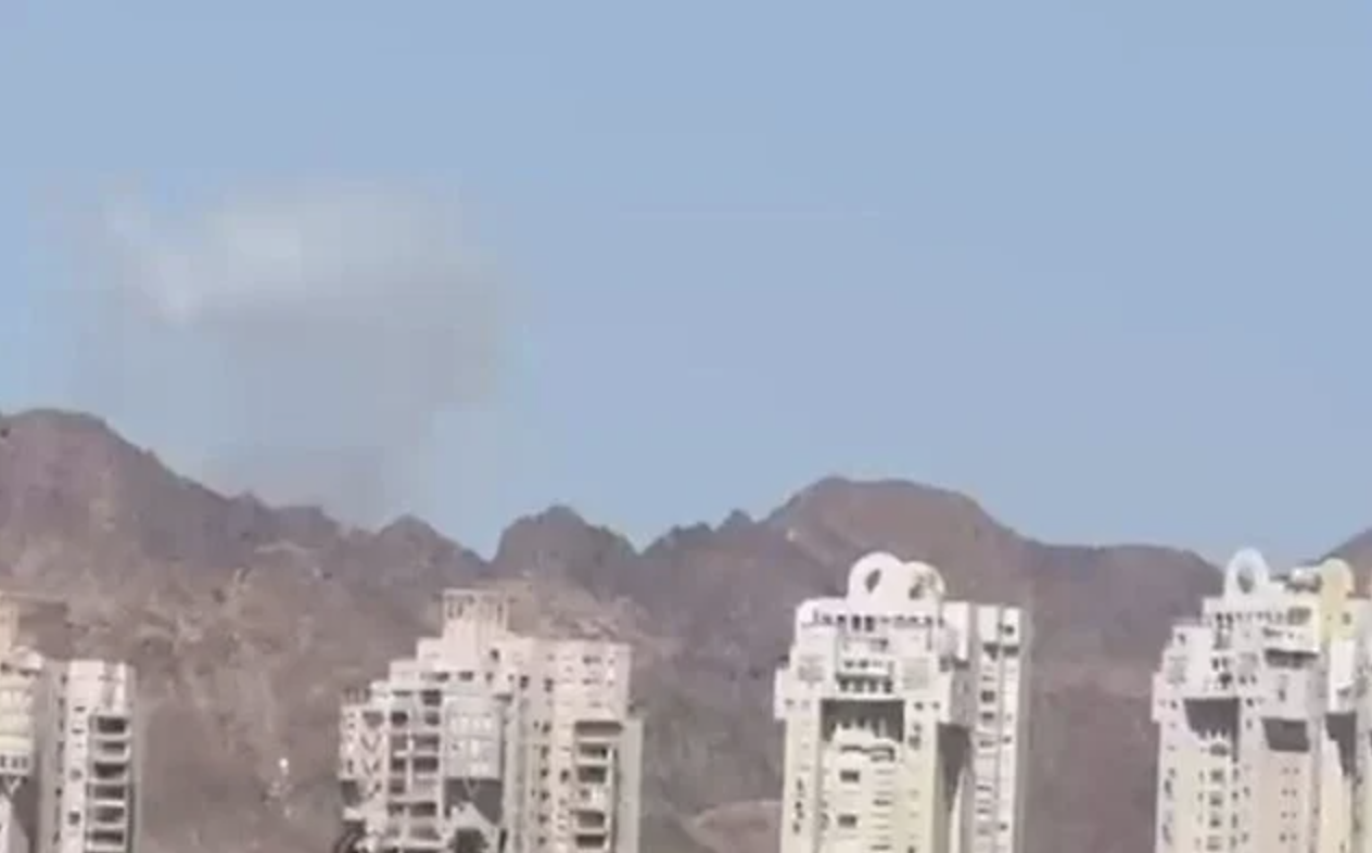 A plume of smoke is seen in the distance from Eilat after an Iranian missile attack on Jordan on July 22, 2026. (Screen capture: Telegram)