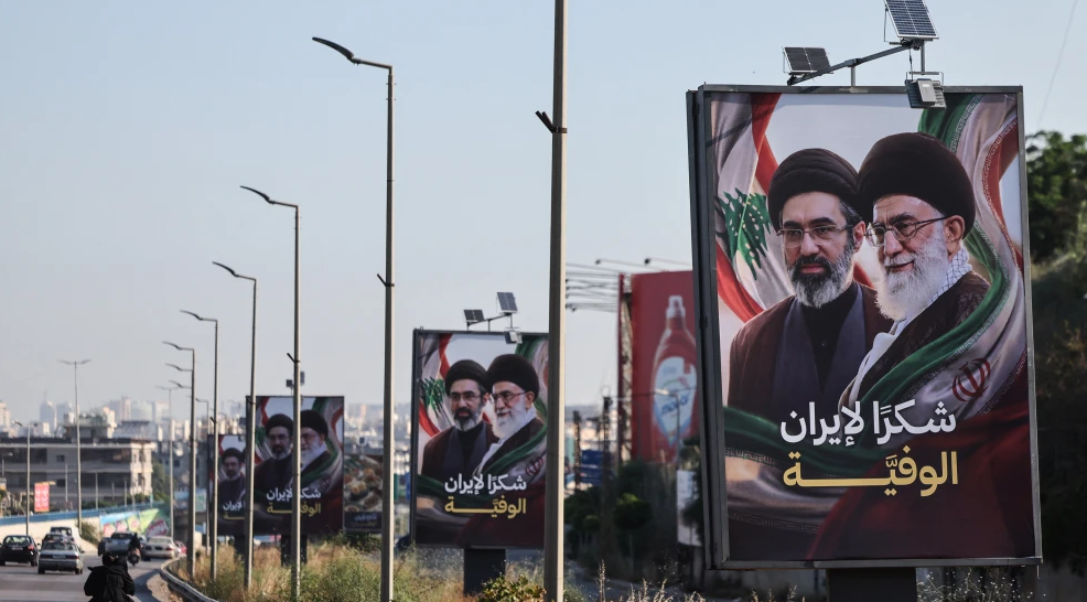 Billboards show Iranian Supreme Leader Mojtaba Khamenei and his late father Ali Khamenei with the slogan “Thank you, loyal Iran” along the highway leading to Beirut’s Rafic Hariri International Airport, June 22, 2026. Photo by Anwar Amro/AFP via Getty Images.