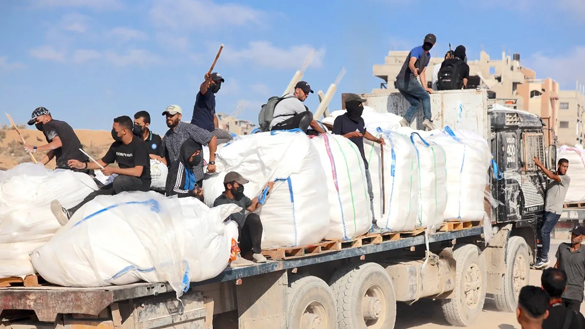 Hamas terrorists carrying clubs and firearms secure and divert humanitarian aid trucks in the northern Gaza area of Jabaliya on June. 25 (TPS-IL)