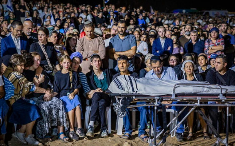 Family and friends attend the funeral of Netanel Shukrun, who was killed in a terror shooting attack at a spring near Neve Tzuf in the West Bank, at the cemetery in his community of Alei Zahav, September 21, 2026. (Hilel Ben Or/Flash90)