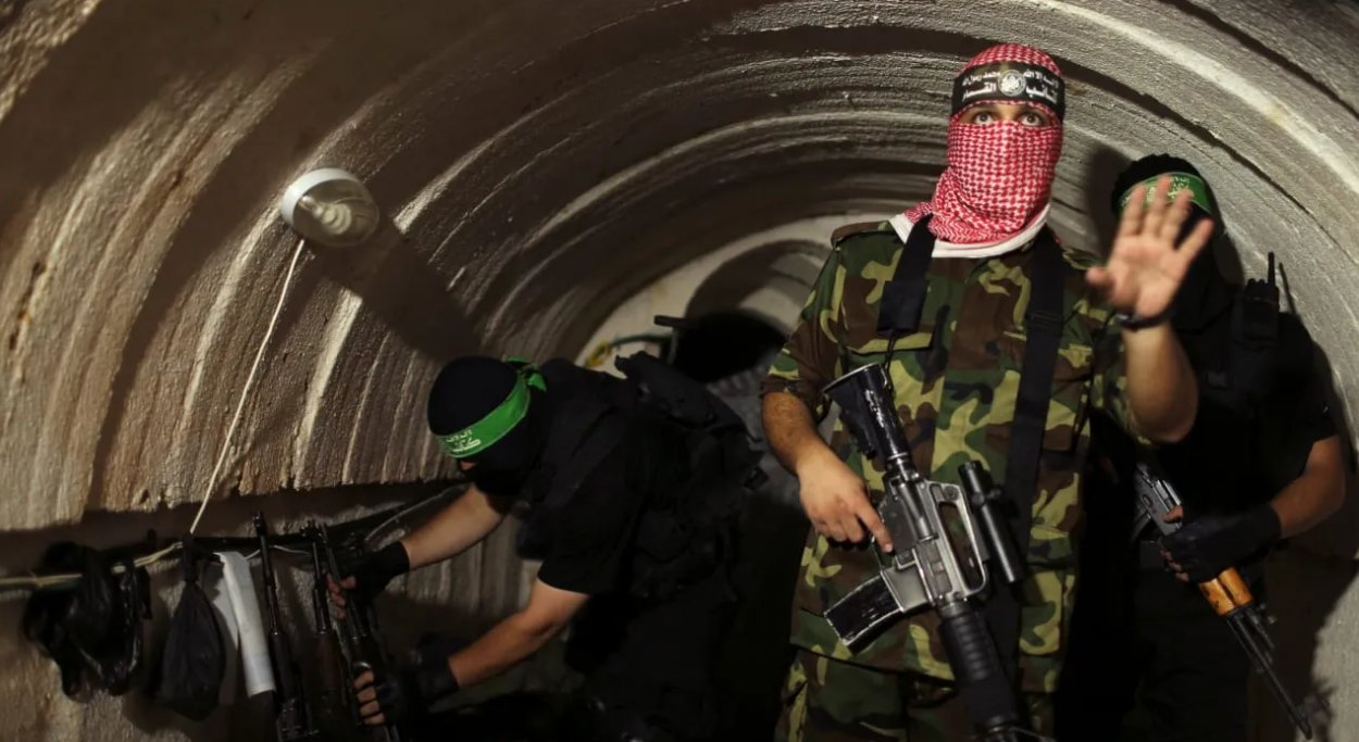 A terrorist from the Izz el-Deen al-Qassam Brigades, the armed wing of the Hamas movement, gestures inside an underground tunnel in Gaza. (photo credit: REUTERS/MOHAMMED SALEM/FILE PHOTO)