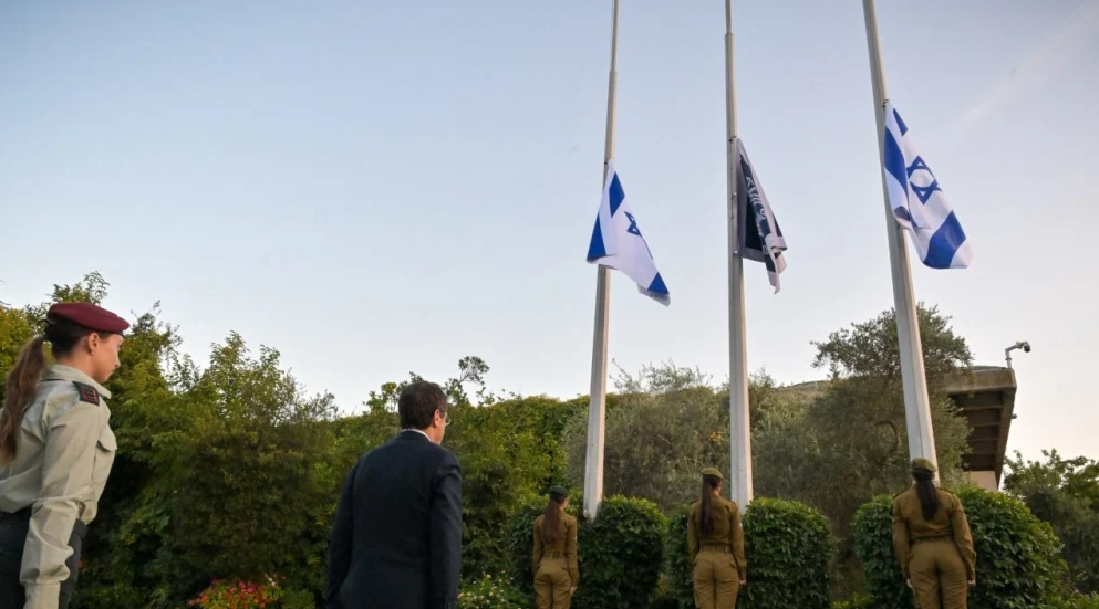 Israeli President Isaac Herzog watches as Israeli flags are lowered to half-staff at 6:29 a.m. at the President’s Residence in Jerusalem, marking the national day of remembrance for the Oct. 7, 2023, terror attacks and the Swords of Iron war, Oct. 5, 2026. Credit: Spokesperson of the Office of the President.