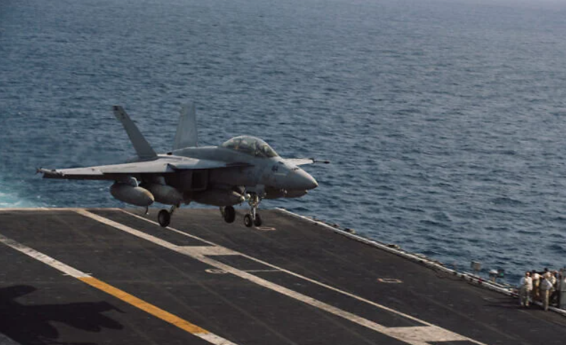 An F/A-18 Super Hornet attached to Strike Fighter Squadron (VFA) 195 lands aboard Nimitz-class aircraft carrier USS George Washington (CVN 73), October 1, 2026, in the Middle East. (U.S. Navy photo)