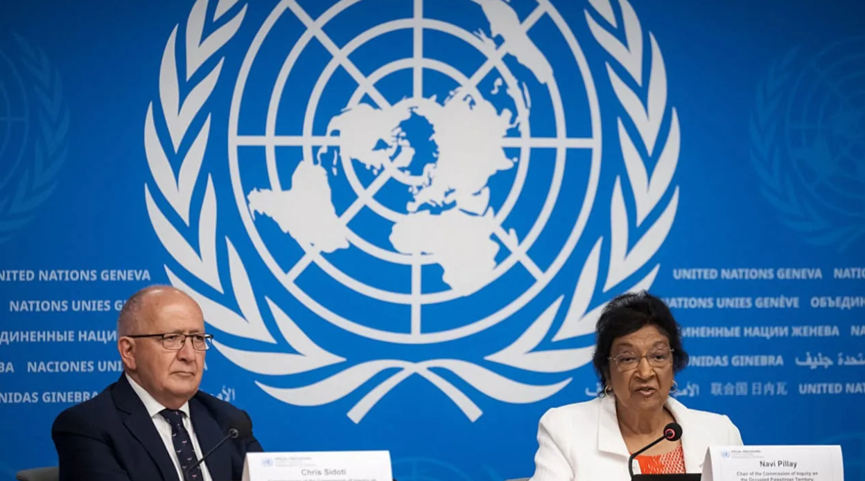Chair of the Independent International Commission of Inquiry on the Occupied Palestinian Territory, including East Jerusalem, and Israel, South African judge Navanethem "Navi" Pillay (R) speaks next to member of the Independent International Commission of Inquiry on the Occupied Palestinian Territor (photo credit: Fabrice COFFRINI / AFP via Getty Images)
